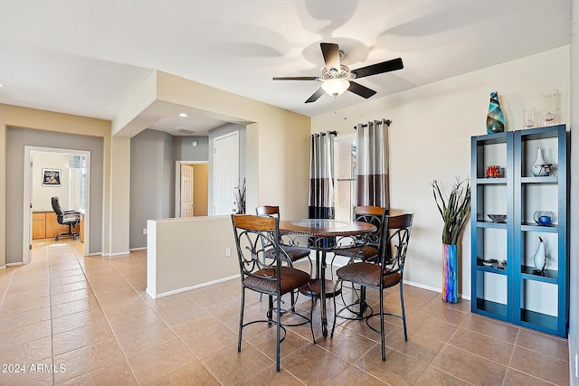 tiled dining area featuring ceiling fan