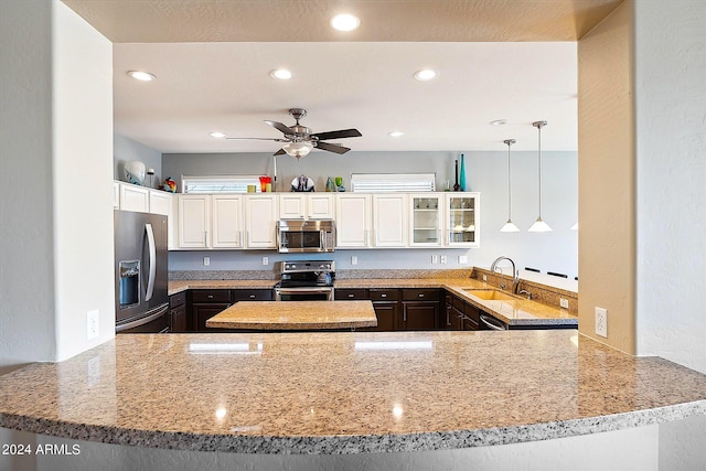 kitchen featuring kitchen peninsula, ceiling fan, sink, stainless steel appliances, and white cabinetry