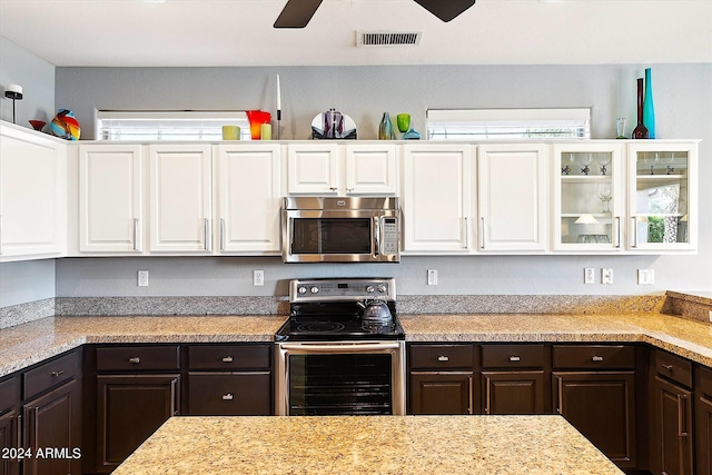 kitchen with stainless steel appliances, light stone countertops, ceiling fan, white cabinets, and dark brown cabinetry