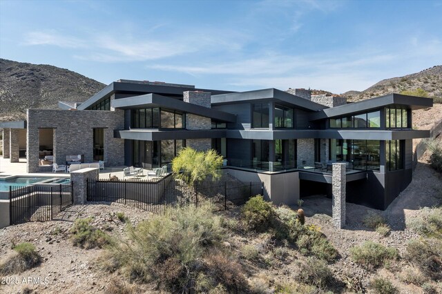 9643 E Cintarosa Pass, Scottsdale, AZ 85262 - back of property with a fenced in pool, a patio, stone siding, and a mountain view