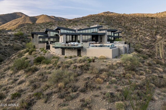 9643 E Cintarosa Pass, Scottsdale, AZ 85262 - back of property with a patio area, stone siding, a mountain view, and an outdoor hangout area
