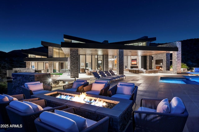 9643 E Cintarosa Pass, Scottsdale, AZ 85262 - patio at twilight with a community pool and an outdoor living space with a fire pit