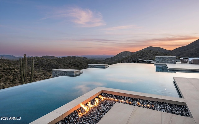 9643 E Cintarosa Pass, Scottsdale, AZ 85262 - view of swimming pool with an outdoor fire pit, a mountain view, and a patio area