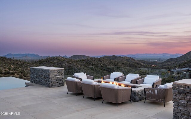 9643 E Cintarosa Pass, Scottsdale, AZ 85262 - patio terrace at dusk with an outdoor living space with a fire pit and a mountain view
