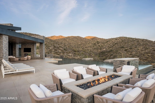 9643 E Cintarosa Pass, Scottsdale, AZ 85262 - view of patio / terrace with an outdoor living space with a fire pit