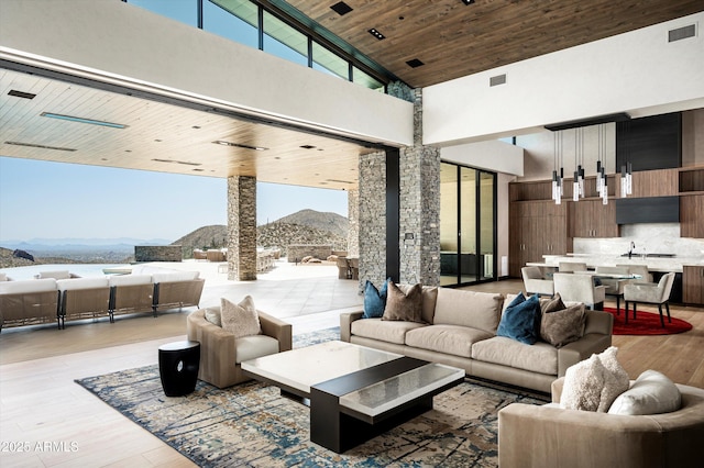 9643 E Cintarosa Pass, Scottsdale, AZ 85262 - living area with a mountain view, light wood-style flooring, a high ceiling, visible vents, and wooden ceiling