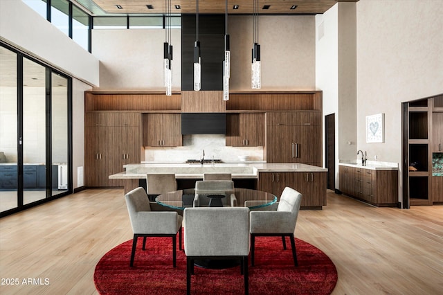 9643 E Cintarosa Pass, Scottsdale, AZ 85262 - dining space featuring light wood finished floors, a towering ceiling, and floor to ceiling windows