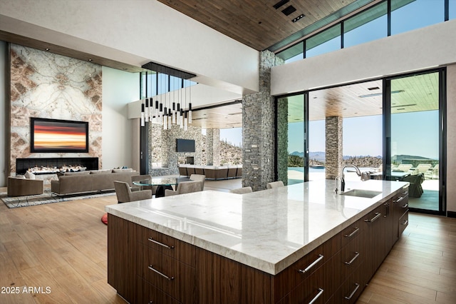 9643 E Cintarosa Pass, Scottsdale, AZ 85262 - kitchen featuring a large island with sink, modern cabinets, a towering ceiling, a sink, and open floor plan
