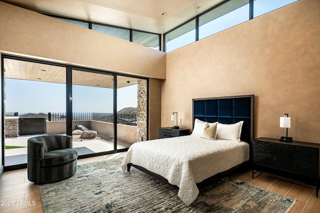 9643 E Cintarosa Pass, Scottsdale, AZ 85262 - bedroom featuring access to outside, a high ceiling, and wood finished floors