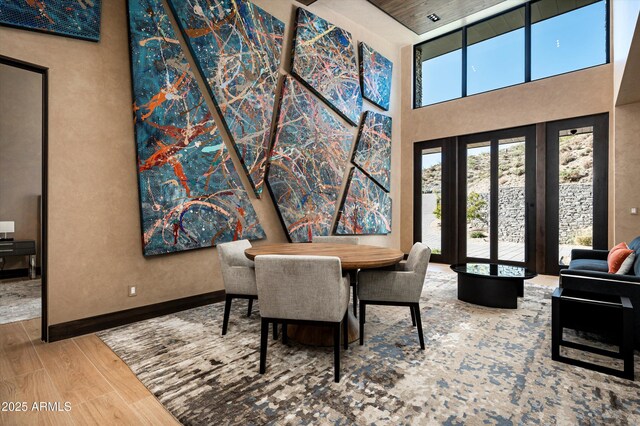 9643 E Cintarosa Pass, Scottsdale, AZ 85262 - dining area featuring a towering ceiling, baseboards, and wood finished floors
