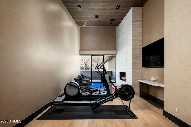 9643 E Cintarosa Pass, Scottsdale, AZ 85262 - workout room with wood ceiling, wood finished floors, baseboards, and a towering ceiling