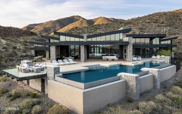 9643 E Cintarosa Pass, Scottsdale, AZ 85262 - back of house featuring a patio, a mountain view, stone siding, an outdoor hangout area, and a jacuzzi