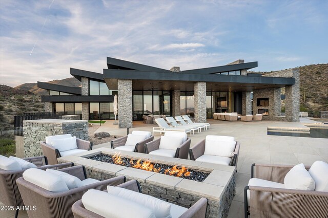 9643 E Cintarosa Pass, Scottsdale, AZ 85262 - view of patio / terrace featuring a mountain view and an outdoor living space with a fire pit