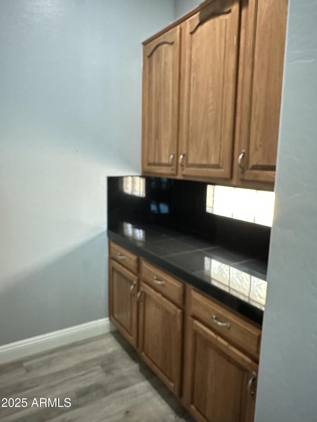 13259 W Flower St, Litchfield Park, AZ 85340 - kitchen featuring baseboards, dark countertops, and light wood-style floors