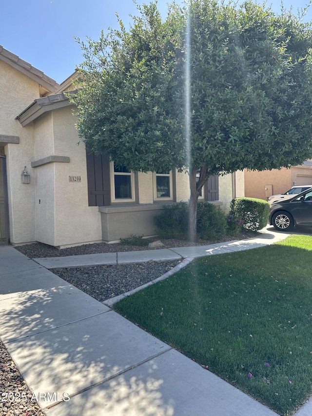 13259 W Flower St, Litchfield Park, AZ 85340 - exterior space with stucco siding and a front yard