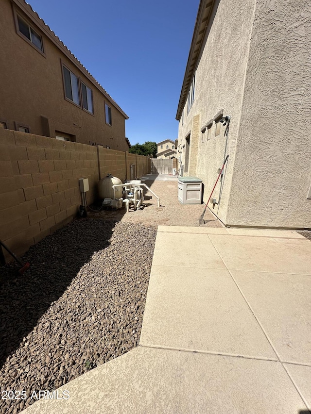 13259 W Flower St, Litchfield Park, AZ 85340 - view of side of property featuring a patio, a fenced backyard, and stucco siding