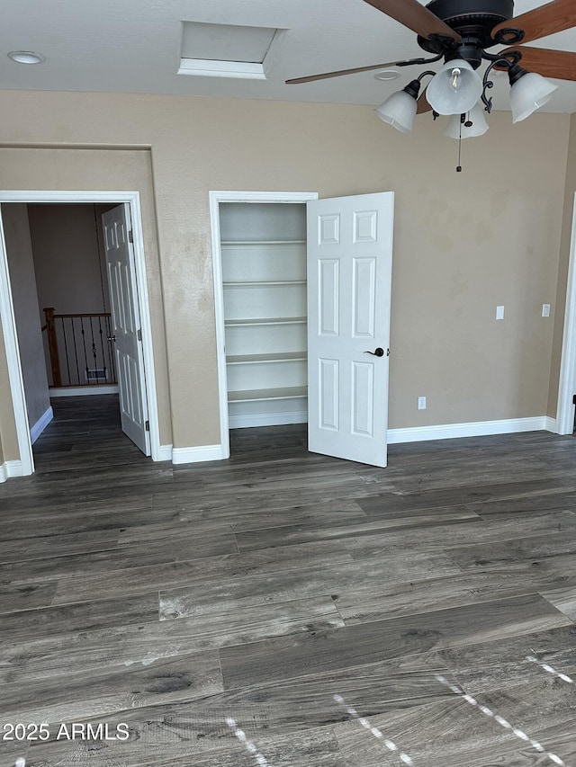 13259 W Flower St, Litchfield Park, AZ 85340 - unfurnished bedroom featuring wood finished floors, a closet, attic access, baseboards, and a ceiling fan
