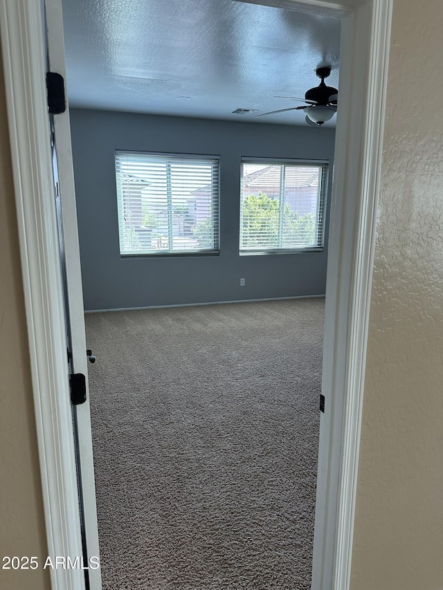 13259 W Flower St, Litchfield Park, AZ 85340 - carpeted empty room featuring baseboards, a ceiling fan, and a textured ceiling
