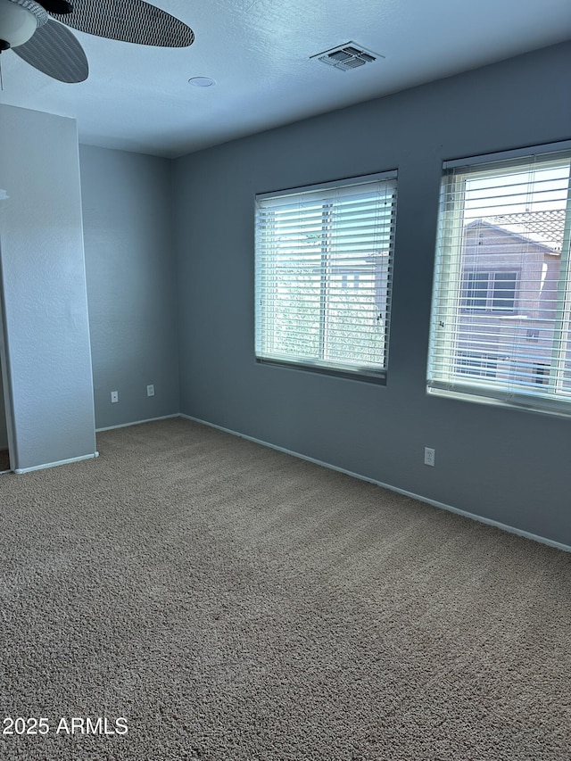 13259 W Flower St, Litchfield Park, AZ 85340 - carpeted spare room with baseboards, visible vents, and a ceiling fan