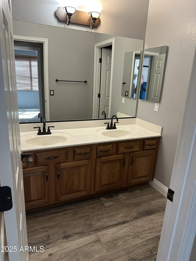 13259 W Flower St, Litchfield Park, AZ 85340 - bathroom with wood finished floors, double vanity, and a sink