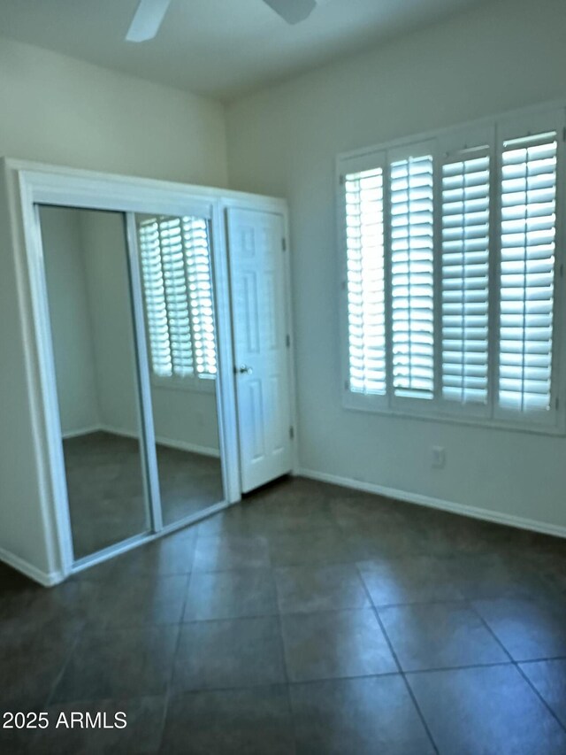 13259 W Flower St, Litchfield Park, AZ 85340 - unfurnished bedroom featuring ceiling fan, tile patterned flooring, and baseboards