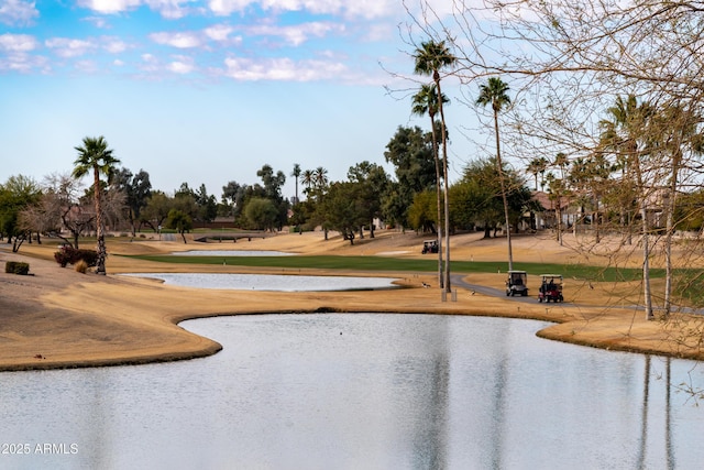 surrounding community featuring golf course view, a water view, and a lawn