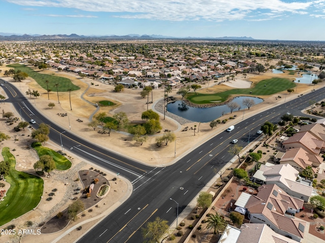 aerial view with view of golf course, a water view, and a residential view