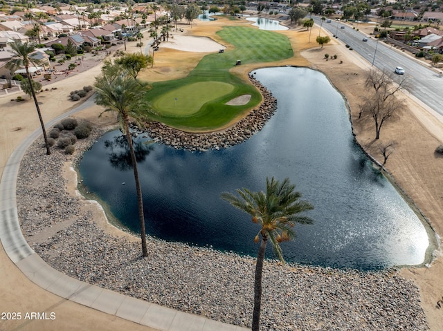 birds eye view of property featuring view of golf course and a water view