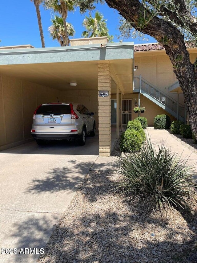 exterior space with driveway and an attached carport