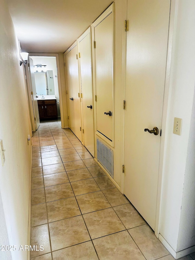 corridor with light tile patterned floors and visible vents