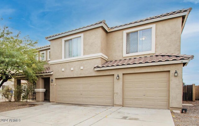436 N 10th Pl, Coolidge, AZ 85128 - townhome / multi-family property featuring a tiled roof, stucco siding, a garage, and driveway
