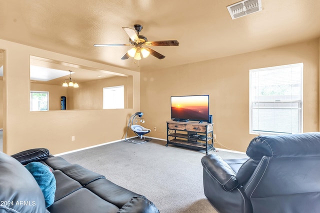 436 N 10th Pl, Coolidge, AZ 85128 - carpeted living area featuring ceiling fan with notable chandelier, baseboards, and visible vents