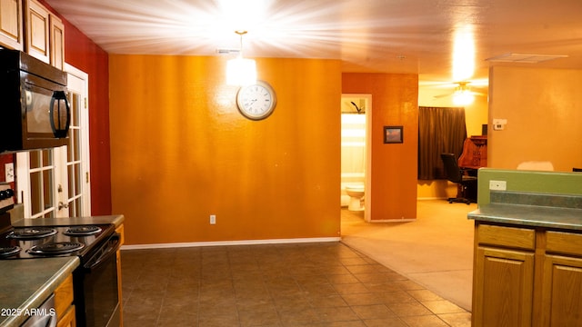28921 N 220th Dr, Wittmann, AZ 85361 - kitchen featuring black appliances, dark countertops, dark tile patterned flooring, pendant lighting, and brown cabinets
