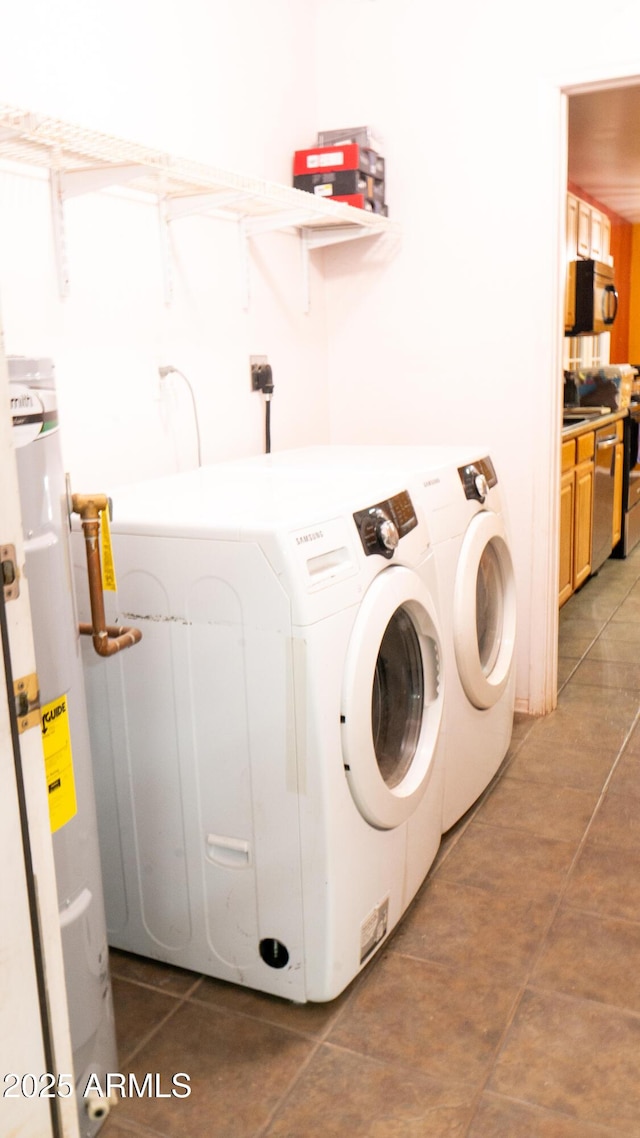 28921 N 220th Dr, Wittmann, AZ 85361 - laundry room with washing machine and clothes dryer, light tile patterned flooring, and gas water heater
