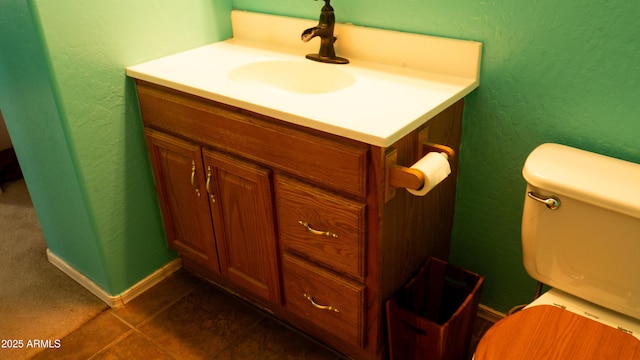 28921 N 220th Dr, Wittmann, AZ 85361 - half bath featuring vanity, toilet, tile patterned flooring, a textured wall, and baseboards