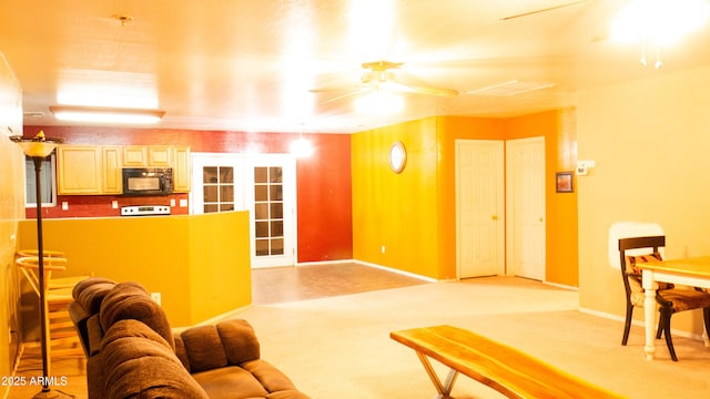 28921 N 220th Dr, Wittmann, AZ 85361 - living area featuring a ceiling fan, baseboards, and light colored carpet