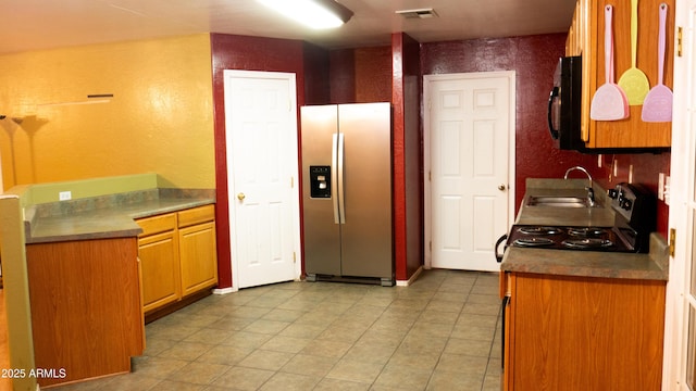 28921 N 220th Dr, Wittmann, AZ 85361 - kitchen with stainless steel fridge with ice dispenser, a sink, light tile patterned flooring, black microwave, and a textured wall