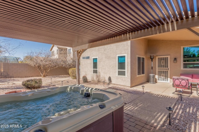 view of patio / terrace with a pergola and a hot tub