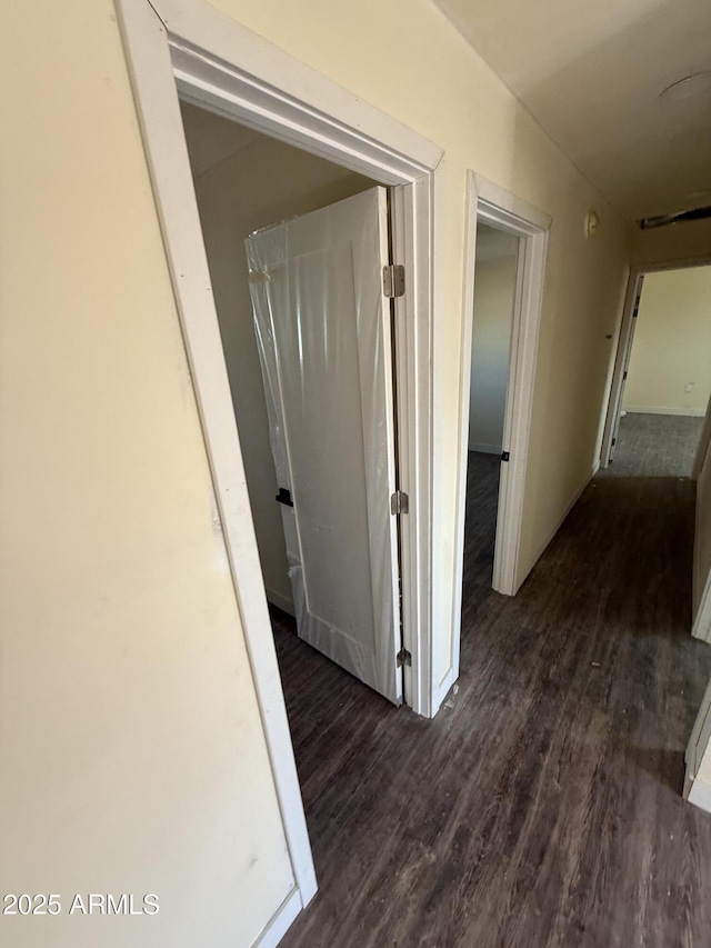 hallway with dark hardwood / wood-style flooring