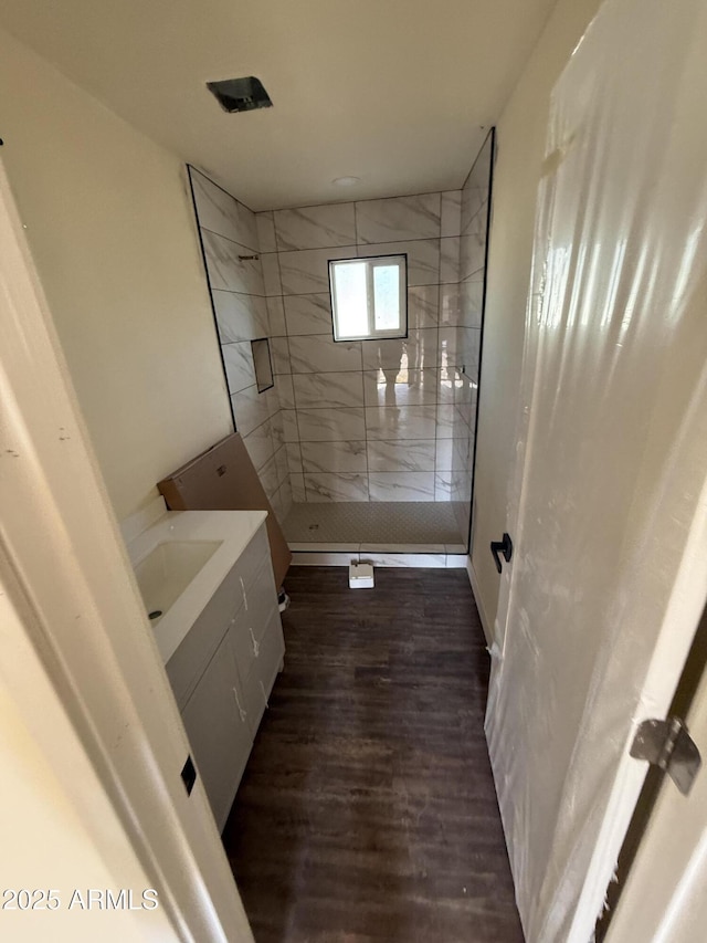 bathroom featuring vanity, a shower with shower door, and hardwood / wood-style floors