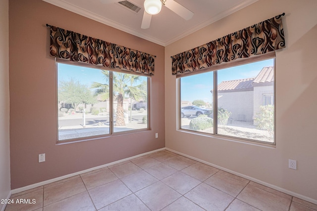 tiled empty room with ceiling fan and ornamental molding