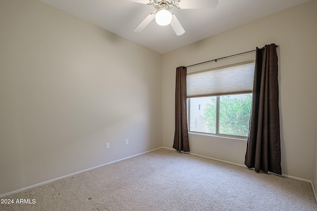 carpeted spare room with ceiling fan