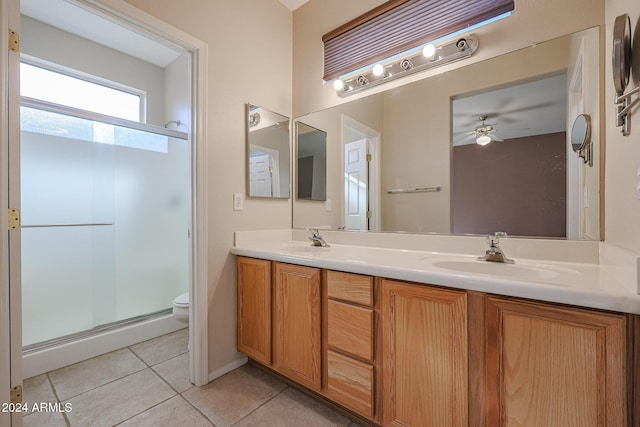 bathroom featuring tile patterned floors, walk in shower, vanity, ceiling fan, and toilet