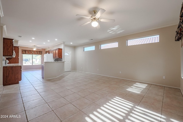 interior space with light tile patterned floors, ceiling fan, and crown molding