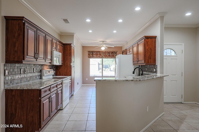 kitchen with tasteful backsplash, crown molding, light tile patterned floors, and white appliances