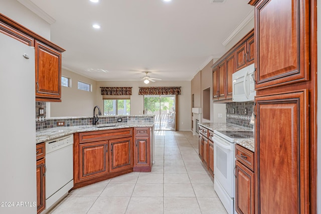 kitchen featuring ceiling fan, sink, kitchen peninsula, white appliances, and ornamental molding