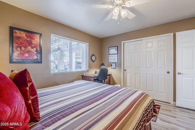 bedroom with light hardwood / wood-style flooring, a closet, and ceiling fan