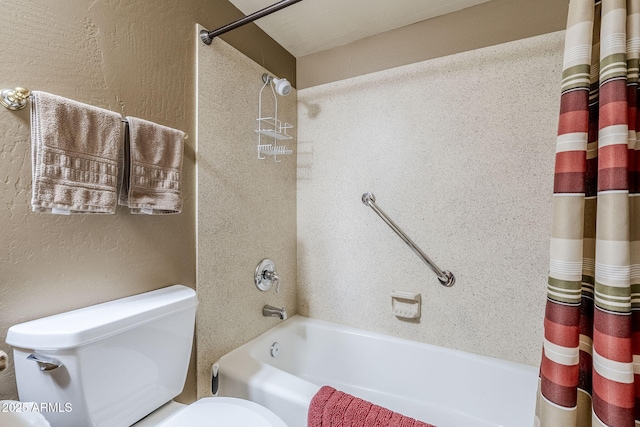 bathroom featuring shower / bath combo and toilet