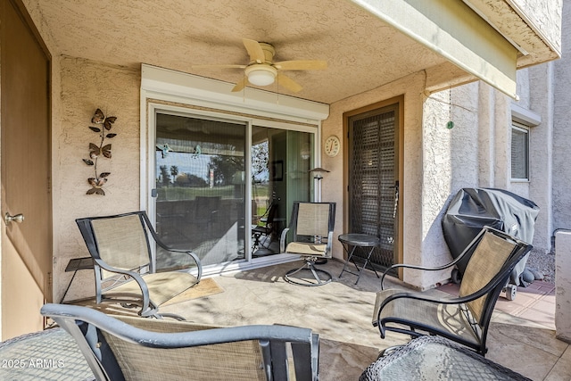 view of patio featuring ceiling fan and a grill