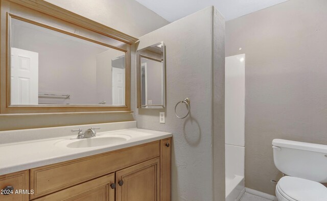 bathroom featuring walk in shower, vanity, and toilet